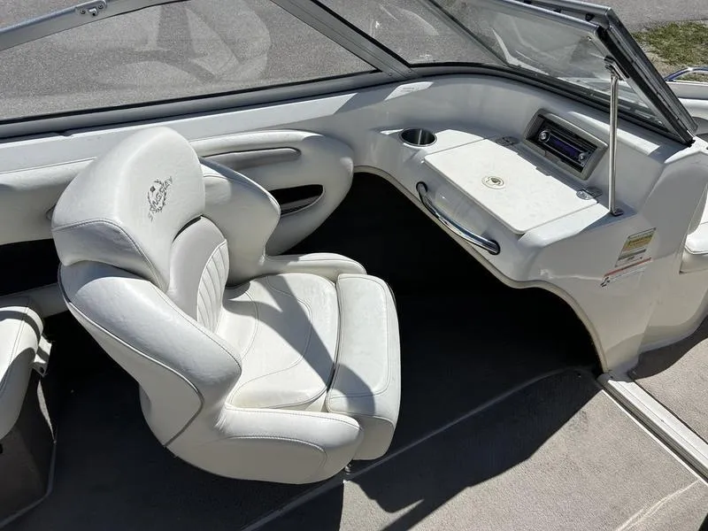 Slide: The Image of 2007 Stingray 210LR boat interior with white seating and dashboard. - 11