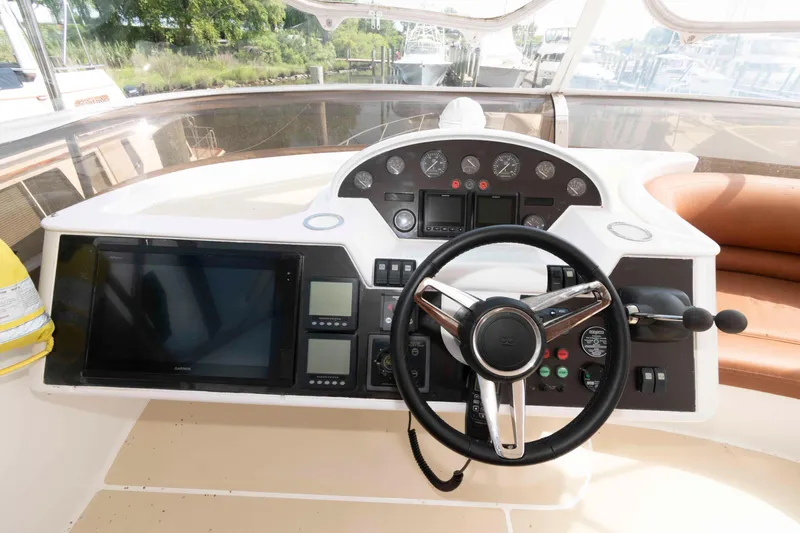 Slide: The Image of Helm of 2003 Princess 50 yacht with steering wheel and navigation controls. - 12