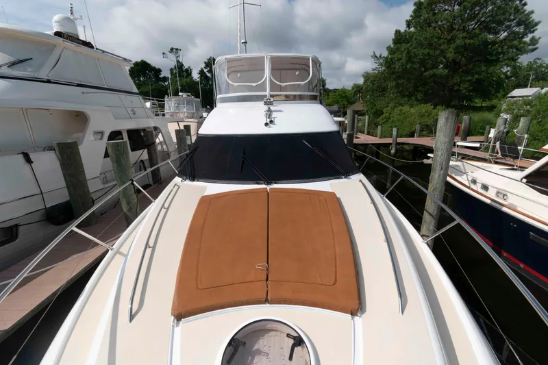 Slide: The Image of 2003 Princess 50 yacht docked, featuring a spacious deck and sleek design. - 14