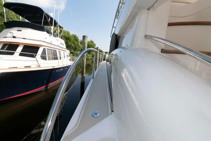 Slide: The Image of Side view of a 2003 Princess 50 yacht docked beside another boat. - 15