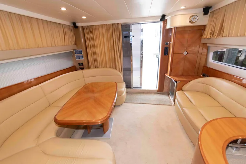 Slide: The Image of Luxurious interior of a 2003 Princess 50 yacht with elegant seating and wooden accents. - 18
