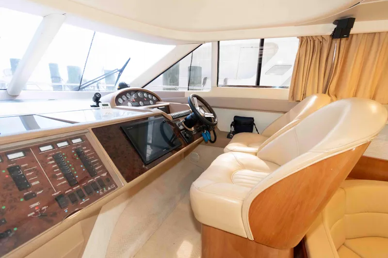 Slide: The Image of Luxurious 2003 Princess 50 yacht cockpit with leather seats and advanced control panel. - 23