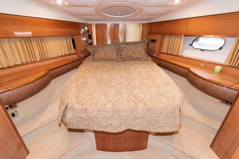 Slide: The Image of Luxurious cabin interior of a 2003 Princess 50 yacht with elegant bedding and wood finishes. - 27