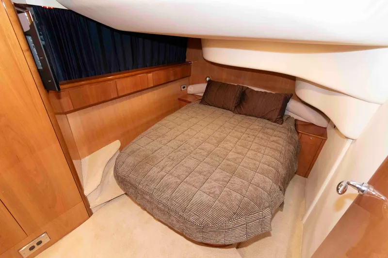 Slide: The Image of Luxurious cabin interior of 2003 Princess 50 yacht with cozy bed and wooden accents. - 29