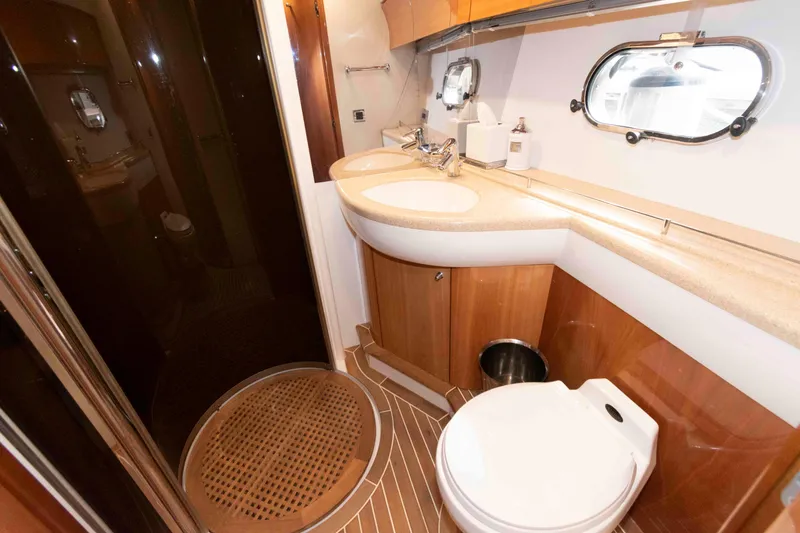Slide: The Image of Luxurious bathroom in 2003 Princess 50 yacht with modern fixtures and wooden accents. - 30