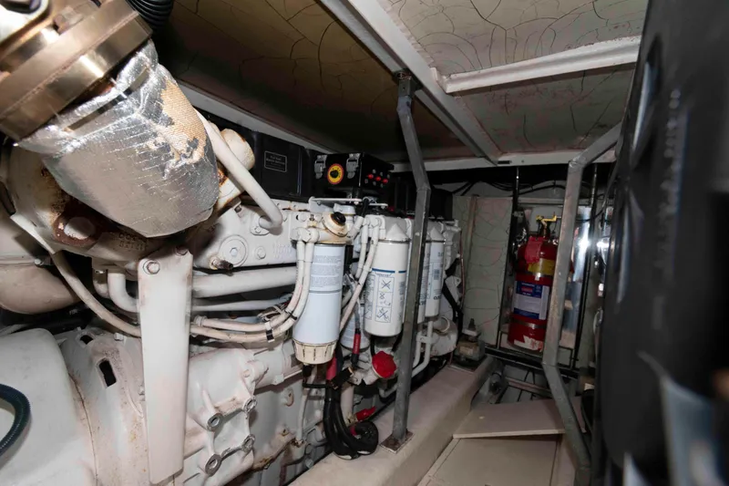 Slide: The Image of Engine room of a 2003 Princess 50 yacht, showcasing mechanical components and filters. - 34