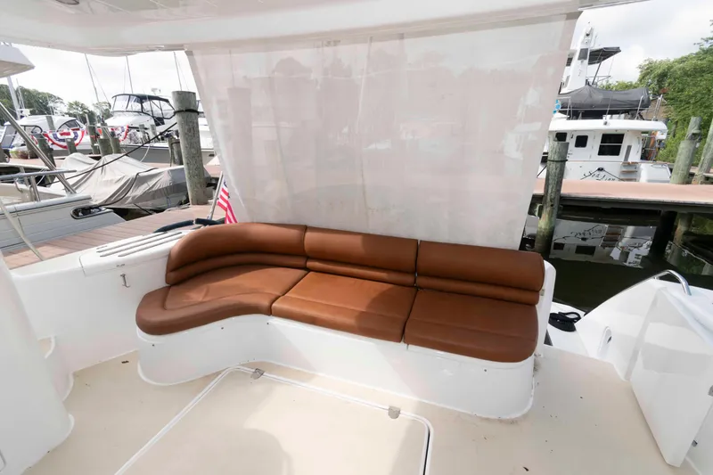 Slide: The Image of Luxurious seating on a 2003 Princess 50 yacht, docked at a marina. - 7