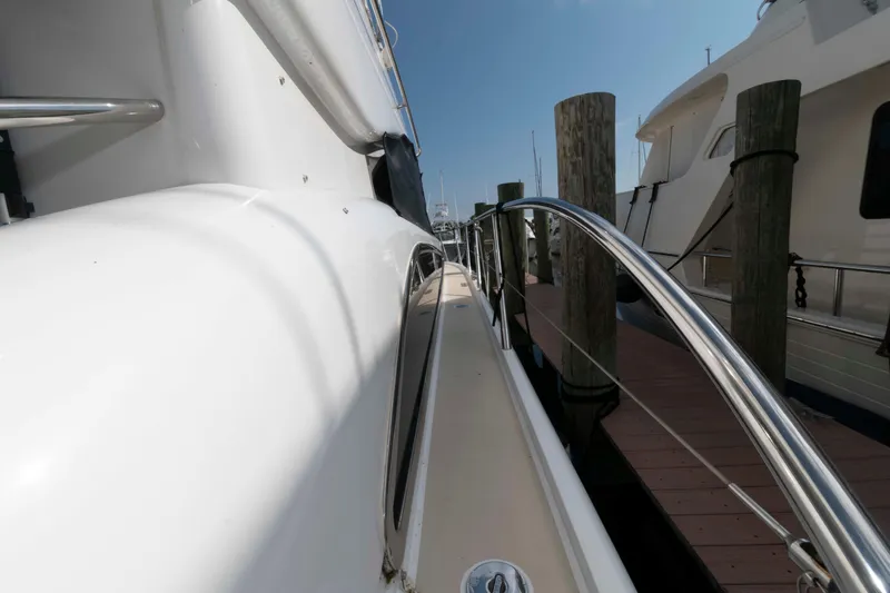 Slide: The Image of Side view of a 2003 Princess 50 yacht docked at a marina. - 16