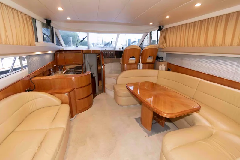 Slide: The Image of Luxurious interior of a 2003 Princess 50 yacht with beige leather seating and wooden accents. - 17