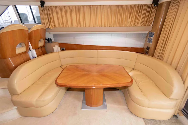 Slide: The Image of Luxurious interior of 2003 Princess 50 yacht with beige leather seating and wooden table. - 20