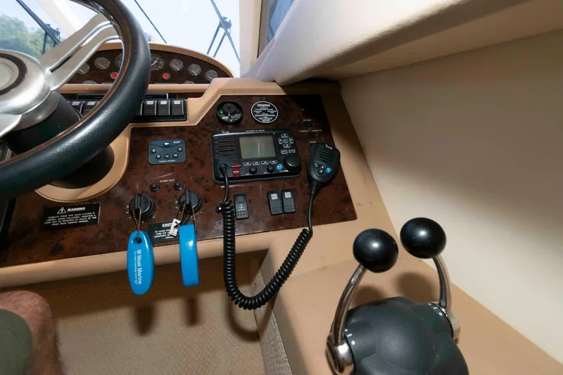 Slide: The Image of Control panel of a 2003 Princess 50 yacht with steering wheel and communication equipment. - 24