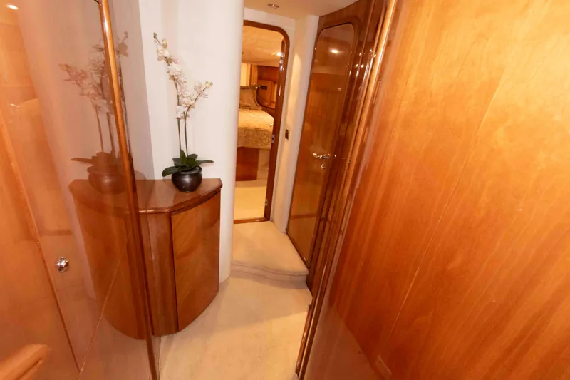 Slide: The Image of Luxurious hallway inside 2003 Princess 50 yacht with wooden paneling and elegant decor. - 26