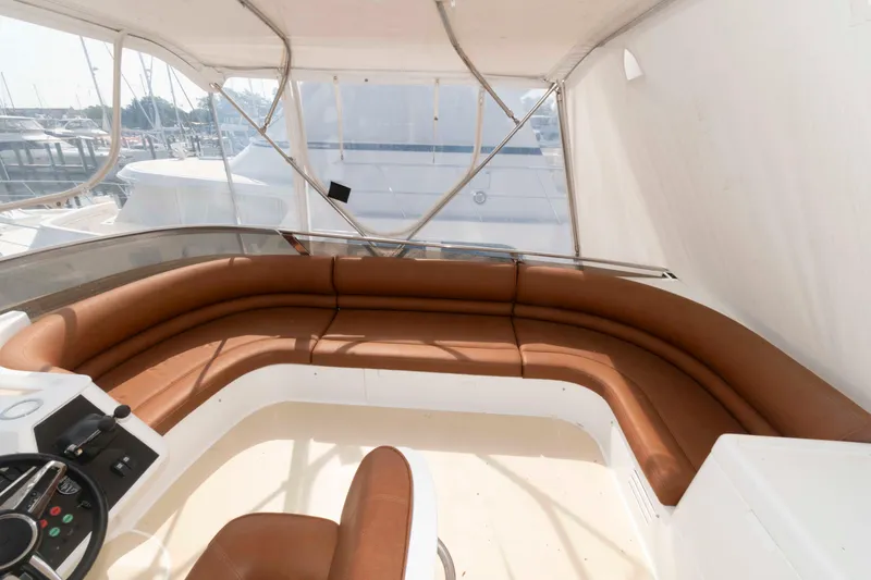 Slide: The Image of Luxurious seating area on a 2003 Princess 50 yacht, featuring brown leather upholstery. - 9