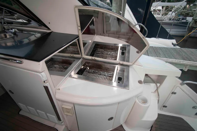 Slide: The Image of Outdoor grill on 2003 Regal Commodore 4260 yacht, featuring stainless steel design. - 13