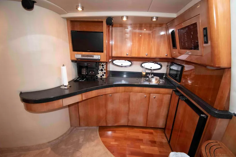 Slide: The Image of Luxurious 2003 Regal Commodore 4260 yacht interior with modern kitchen amenities. - 15