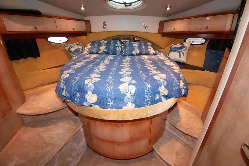 Slide: The Image of Luxurious 2003 Regal Commodore 4260 yacht bedroom with nautical-themed bedding. - 18