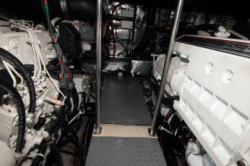 Slide: The Image of Engine room of a 2003 Regal Commodore 4260 yacht, featuring dual engines and metallic flooring. - 22