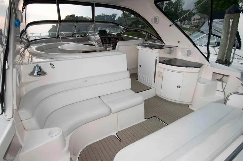 Slide: The Image of 2003 Regal Commodore 4260 yacht interior with white seating and helm station. - 5