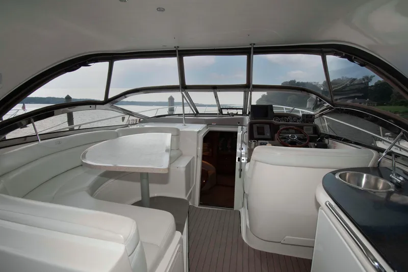 Slide: The Image of Interior of 2003 Regal Commodore 4260 yacht with helm, seating, and table. - 6