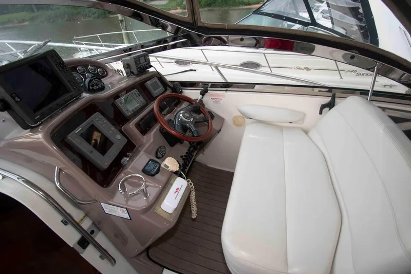 Slide: The Image of 2003 Regal Commodore 4260 helm with modern navigation equipment and white seating. - 7