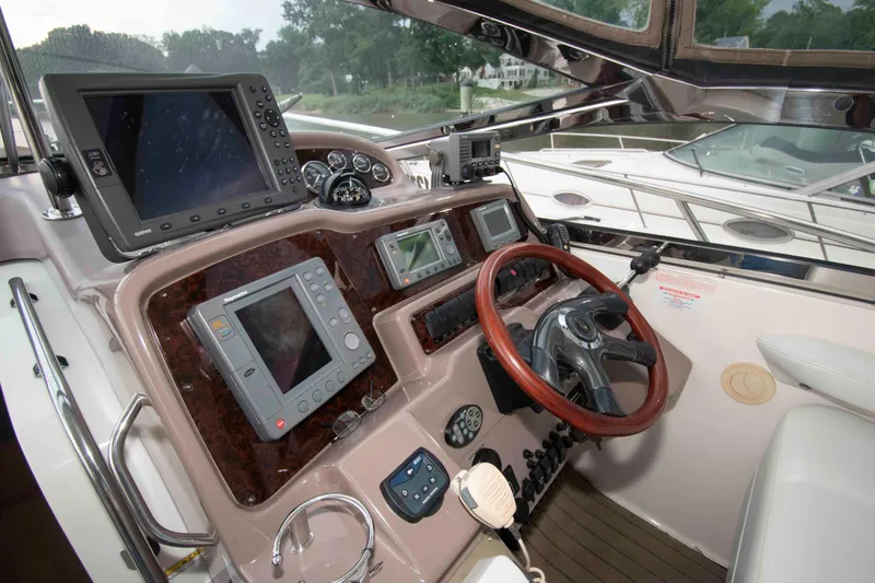 Slide: The Image of Helm of 2003 Regal Commodore 4260 with navigation equipment and wooden steering wheel. - 8