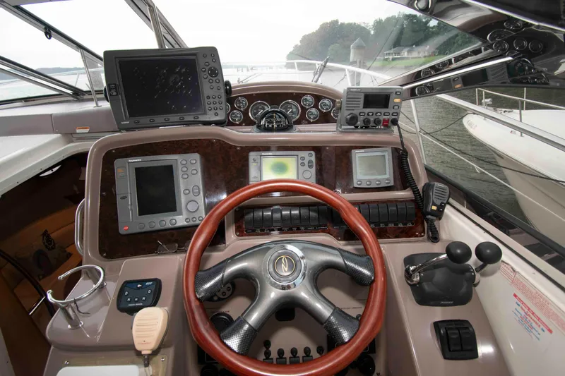 Slide: The Image of Cockpit of 2003 Regal Commodore 4260 yacht with navigation equipment and steering wheel. - 9
