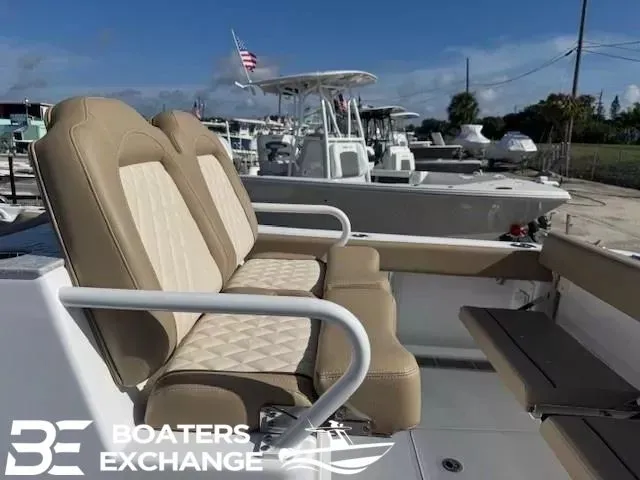 Slide: The Image of Everglades 285 Center Console 2026 with beige seats at the marina. - 6