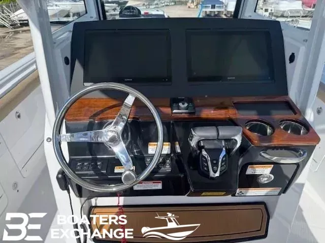Slide: The Image of 2026 Everglades 285 Center Console helm with wood accents. - 8