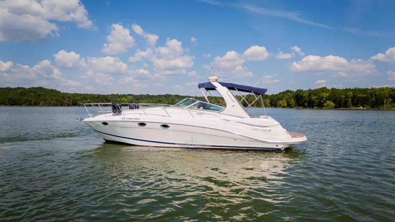 Slide: The Image of 2006 Four Winns 348 Vista boat cruising on a lake under a blue sky. - 10