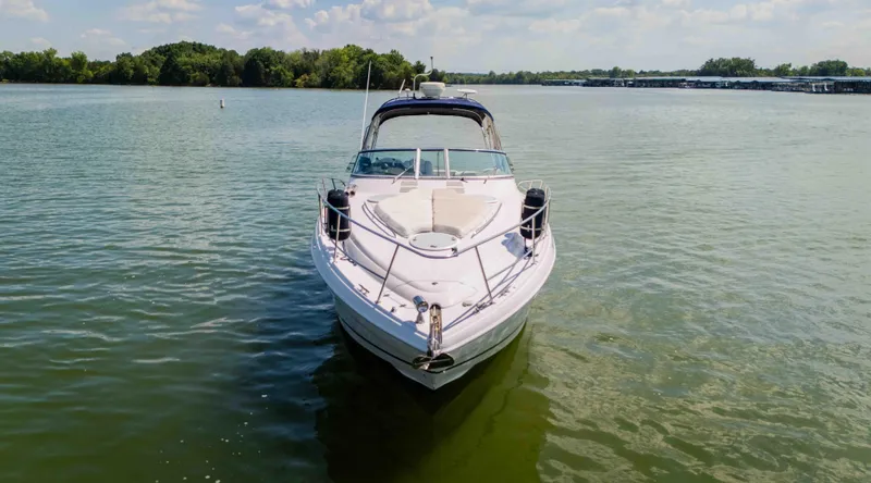 Slide: The Image of 2006 Four Winns 348 Vista boat on calm lake with trees in background. - 13