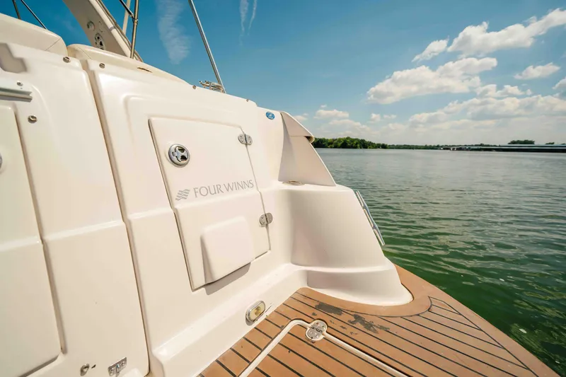 Slide: The Image of 2006 Four Winns 348 Vista boat on calm lake under blue sky. - 26