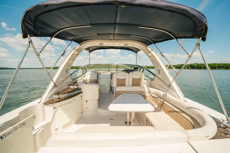 Slide: The Image of 2006 Four Winns 348 Vista yacht interior with seating and table on a sunny day. - 29