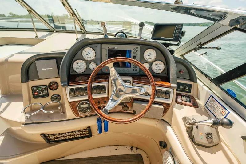 Slide: The Image of 2006 Four Winns 348 Vista boat dashboard with steering wheel and navigation instruments. - 32