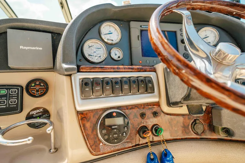 Slide: The Image of 2006 Four Winns 348 Vista boat dashboard with steering wheel and navigation controls. - 34