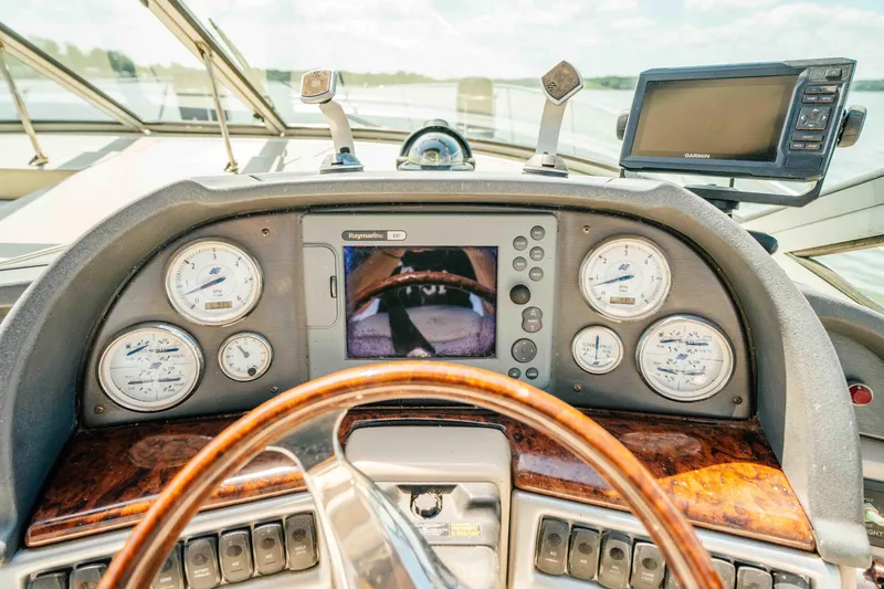 Slide: The Image of Dashboard of 2006 Four Winns 348 Vista boat with gauges and navigation screens. - 35