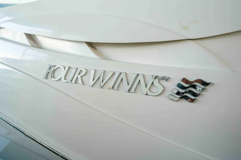 Slide: The Image of 2006 Four Winns 348 Vista boat logo on white hull. - 39