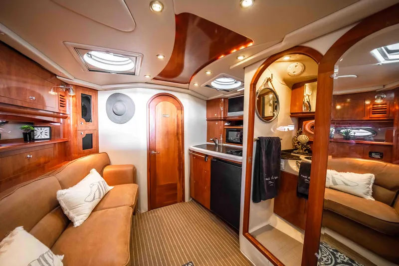 Slide: The Image of Luxurious 2006 Four Winns 348 Vista yacht interior with elegant wood finishes and cozy seating. - 41