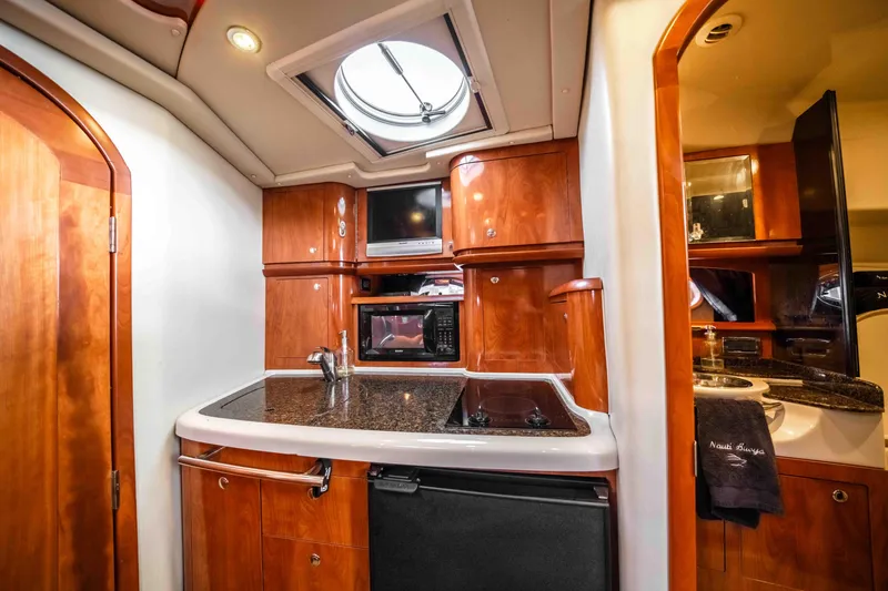 Slide: The Image of Luxurious 2006 Four Winns 348 Vista yacht interior with modern kitchen amenities. - 42