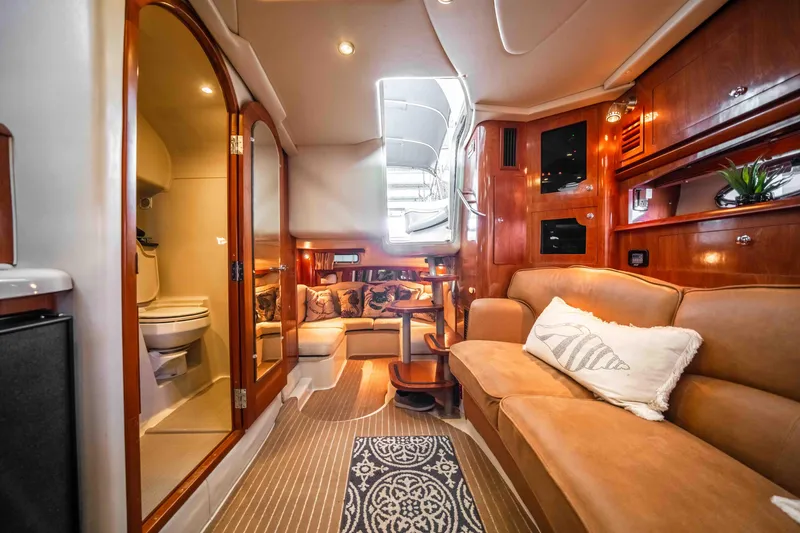 Slide: The Image of Luxurious interior of 2006 Four Winns 348 Vista yacht with cozy seating and elegant wood finishes. - 44