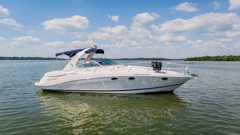 Slide: The Image of 2006 Four Winns 348 Vista yacht on a serene lake under a blue sky. - 7