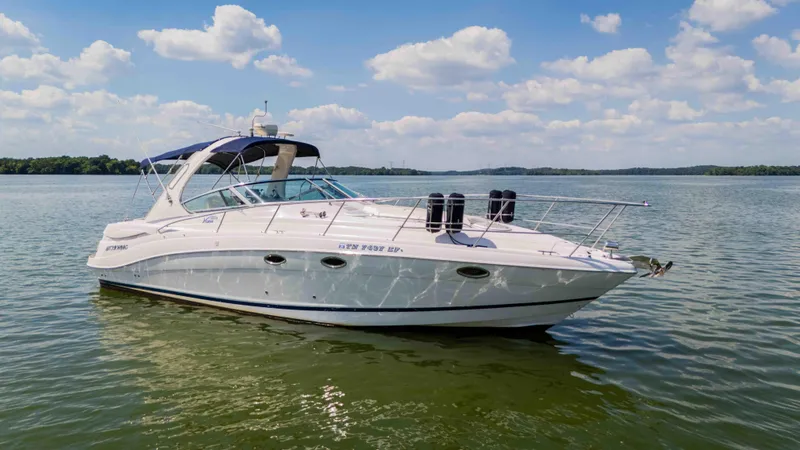 Slide: The Image of 2006 Four Winns 348 Vista boat on calm lake under blue sky. - 8