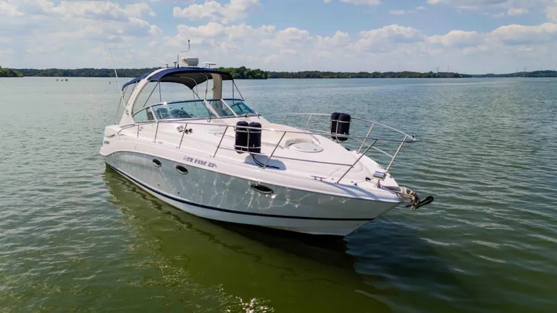 Slide: The Image of 2006 Four Winns 348 Vista boat on calm lake under blue sky. - 9