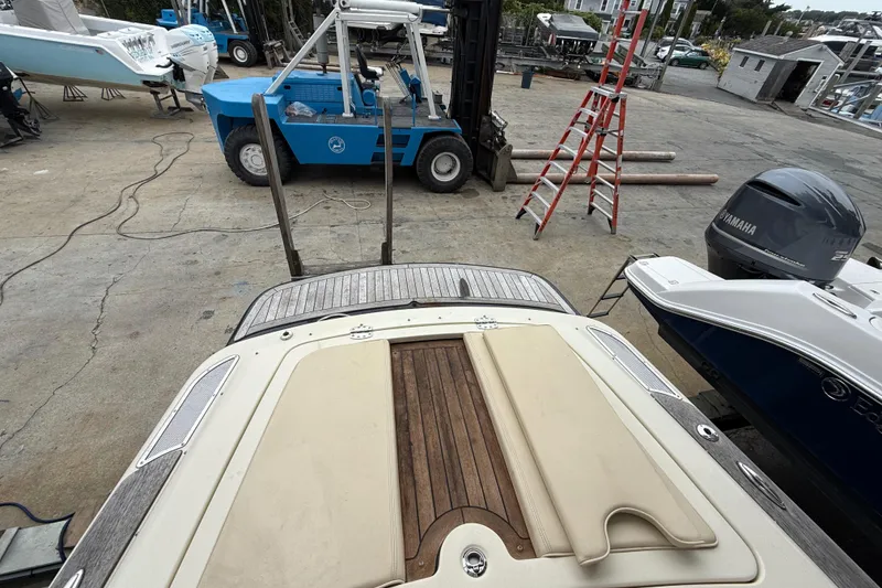 Slide: The Image of 2016 Chris-Craft Launch 22 boat on dock, with forklift and ladder nearby. - 12