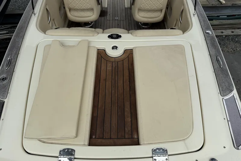 Slide: The Image of 2016 Chris-Craft Launch 22 boat interior with beige seating and wooden deck. - 13