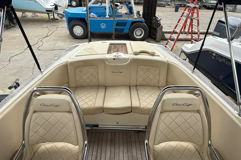Slide: The Image of 2016 Chris-Craft Launch 22 boat interior with beige leather seating and wood flooring. - 2