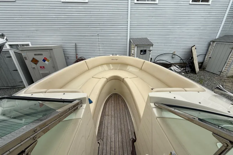 Slide: The Image of 2016 Chris-Craft Launch 22 boat with beige seating and wooden deck, docked near a building. - 3