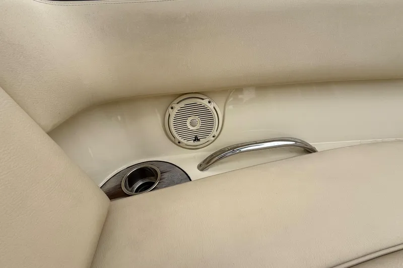 Slide: The Image of 2016 Chris-Craft Launch 22 interior with speaker, cup holder, and beige upholstery. - 7