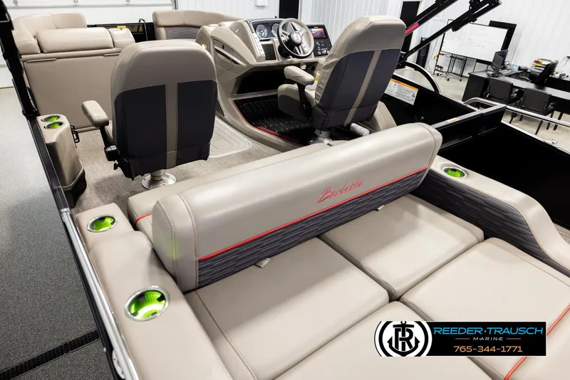 Slide: The Image of 2023 Barletta 21 UC boat interior with plush seating and modern dashboard. - 11