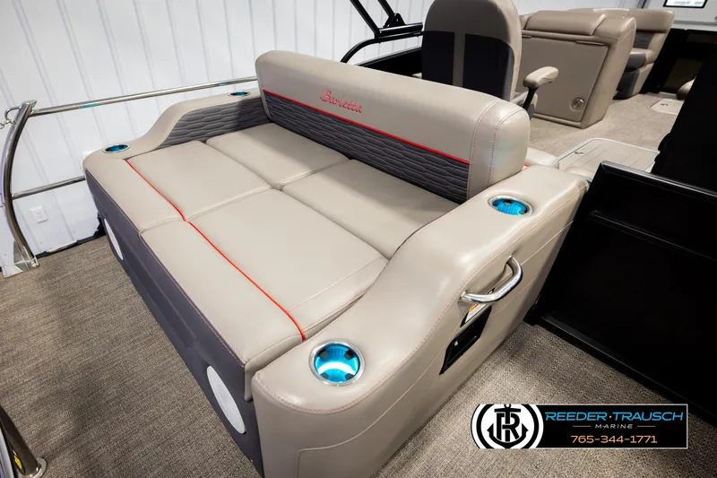 Slide: The Image of 2023 Barletta 21 UC boat interior with beige seating and cup holders. - 24