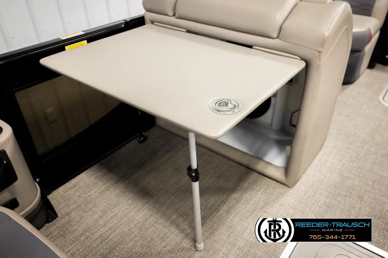 Slide: The Image of 2023 Barletta 21 UC boat interior with foldable table and beige seating. - 31